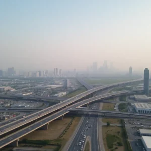 Aerial view of a polluted skyline in Ontario, California with heavy traffic.