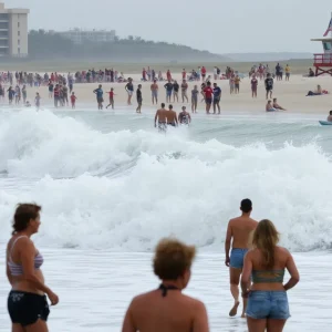 Crowded beach with strong waves and a lifeguard tower