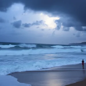 High surf crashing on the beach with stormy clouds in the background