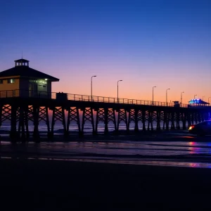 Newport Beach Pier illuminated by police lights