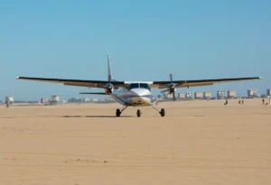 Small airplane landing on Huntington Beach sand